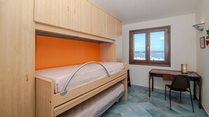 A bedroom with a bunk bed, a desk, and a chair. - Holiday Home 'Mariella' with Sea View and Private Terrace (Palau)