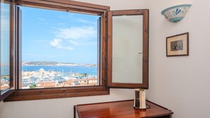 A room with a large window offering a view of a marina and the sea. - Holiday Home 'Mariella' with Sea View and Private Terrace (Palau)