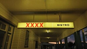 A covered walkway with a sign indicating a bistro.