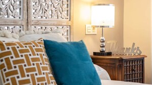 A bed with patterned pillows, a bedside lamp, a decorative wall panel, and a 'Thanks' sign. - Inside old town by Eba Homes (Bilbao)