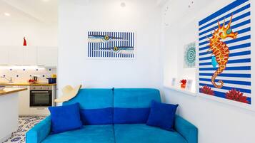 Deluxe Apartment, Sea View | Living area | 32-inch flat-screen TV with digital channels