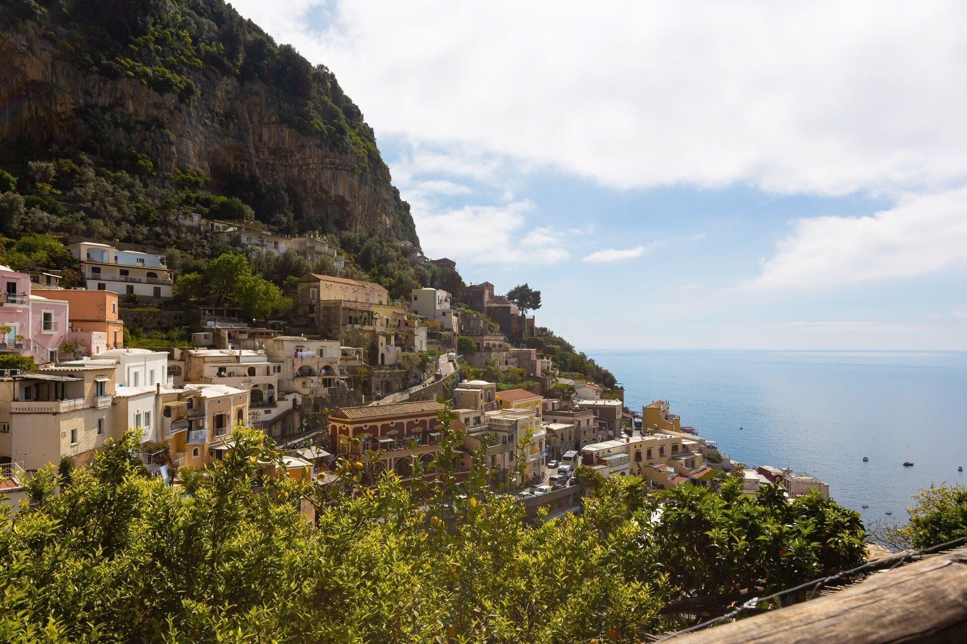 A coastal village with buildings built on a hillside overlooking the sea.