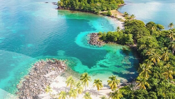 A tropical island with clear turquoise waters, lush greenery, and a small rocky beach area. - Studio Colibri - Terrace 2 pers, 3mn from Anse Mitan beach (Les Trois-Îlets)