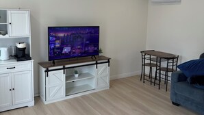 A living room with a TV, a coffee maker, a small table, and a sofa. - Private studio in north Long Beach with refreshing AC (Long Beach)