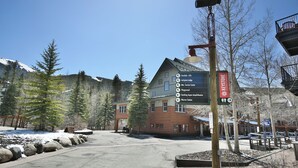 A building with a sign indicating amenities like lifts, lodges, service center, playground, and a station. - Steps to Keystone Weddings, Gondola, Dining! 3 Hot Tubs, Pool, Elevator (Keystone)