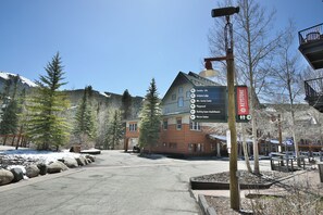 A building with a sign indicating amenities like lifts, lodges, service center, playground, and a station. - Steps to Keystone Weddings, Gondola, Dining! 3 Hot Tubs, Pool, Elevator (Keystone)