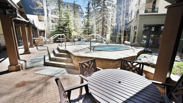A patio area with a hot tub, outdoor seating, and a staircase leading to an upper level. - Steps to Keystone Weddings, Gondola, Dining! 3 Hot Tubs, Pool, Elevator (Keystone)