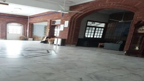A spacious room with a marble floor, brick walls, and a large window. - Hotel Hayatt Sukkur (Sukkur)