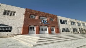 A hotel with a brick facade, multiple arched doorways, and a clear sky. - Hotel Hayatt Sukkur (Sukkur)