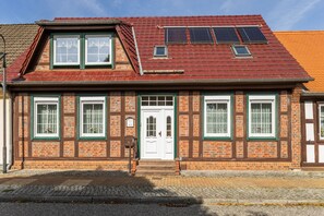 A two-story building with a traditional facade, featuring a symmetrical window arrangement and a central entrance.