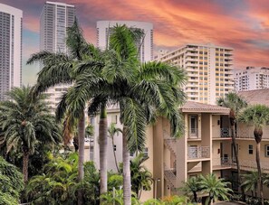 A multi-story building with balconies, surrounded by palm trees. - Beachwalk Studio Intracoastal & Balcony (Hallandale Beach)
