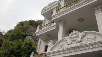 A multi-story building with ornate balconies and classical architectural details.