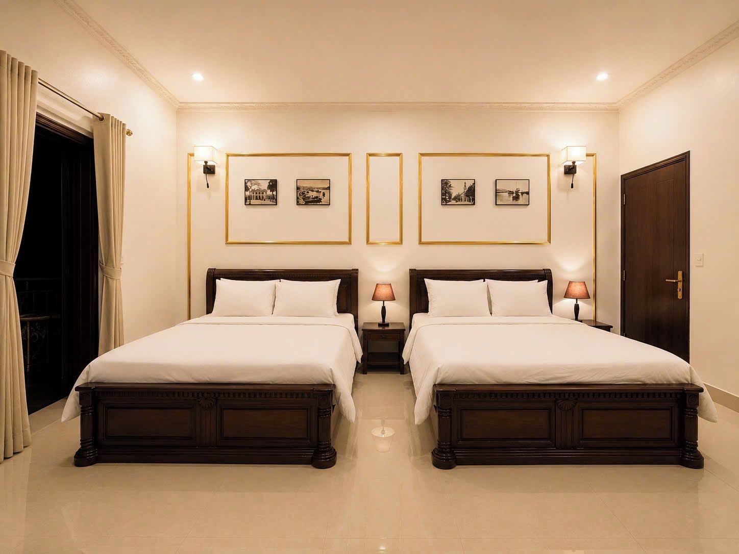 A double bed room with two bedside tables, each with a lamp, and framed pictures on the wall.