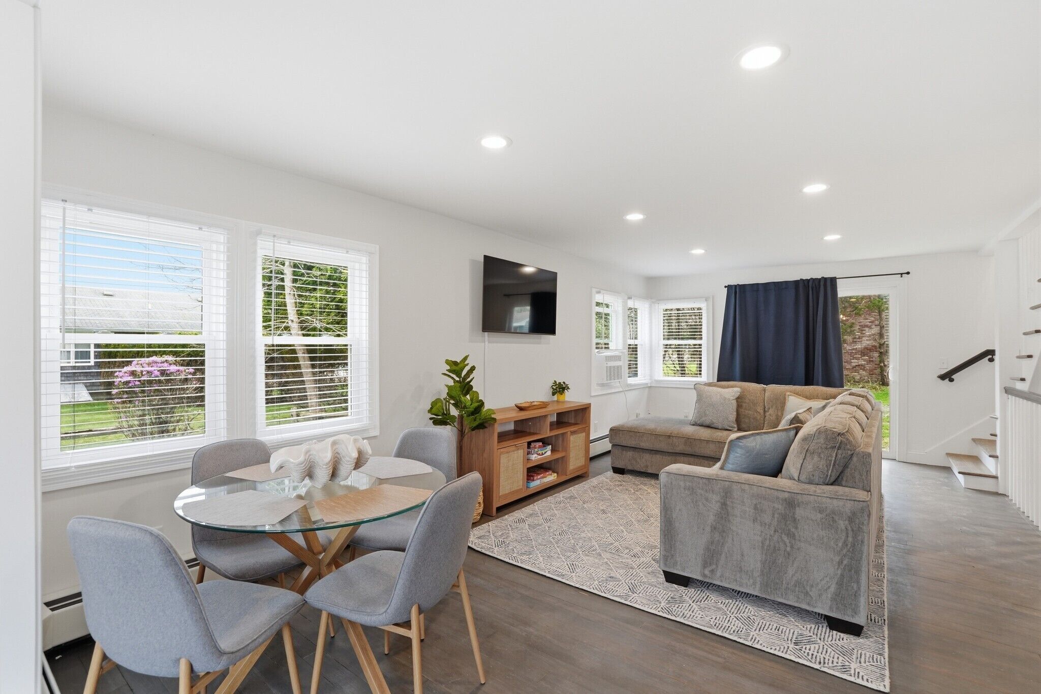 Modern coastal comfort meets ocean breezes in this airy, open-concept space—perfect for gathering around the dinner table or relaxing on the full-sized pullout sofa.