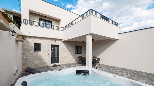 A modern house with a hot tub, a balcony, and a dining area. - Villa Ruzarija with jacuzzi (Sukošan)