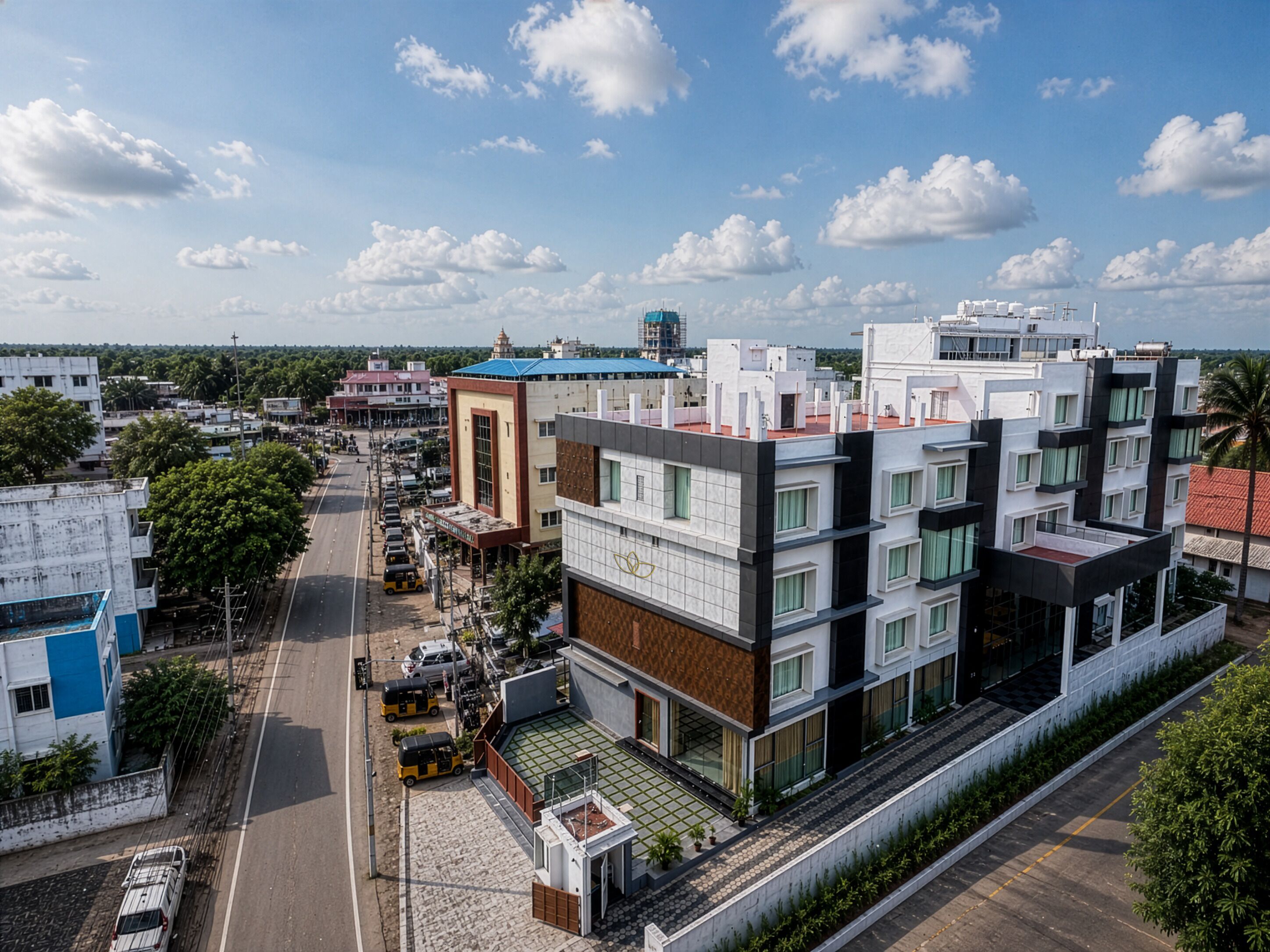 A multi-story hotel with a modern design, featuring a rooftop garden and a view of the surrounding cityscape.
