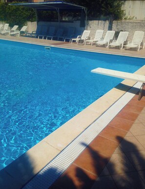 Seasonal outdoor pool, open 10:00 AM to 8:00 PM, pool umbrellas