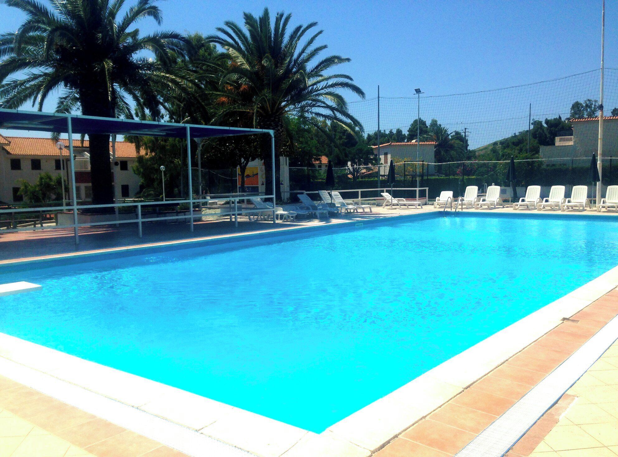 Seasonal outdoor pool, open 10:00 AM to 8:00 PM, pool umbrellas