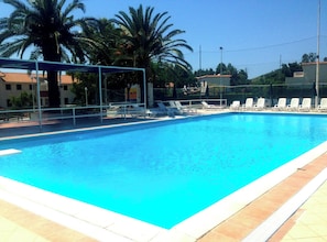 Seasonal outdoor pool, open 10:00 AM to 8:00 PM, pool umbrellas