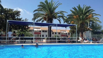 Seasonal outdoor pool, open 10:00 AM to 8:00 PM, pool umbrellas