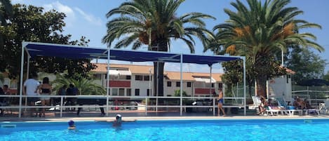 Seasonal outdoor pool, open 10:00 AM to 8:00 PM, pool umbrellas
