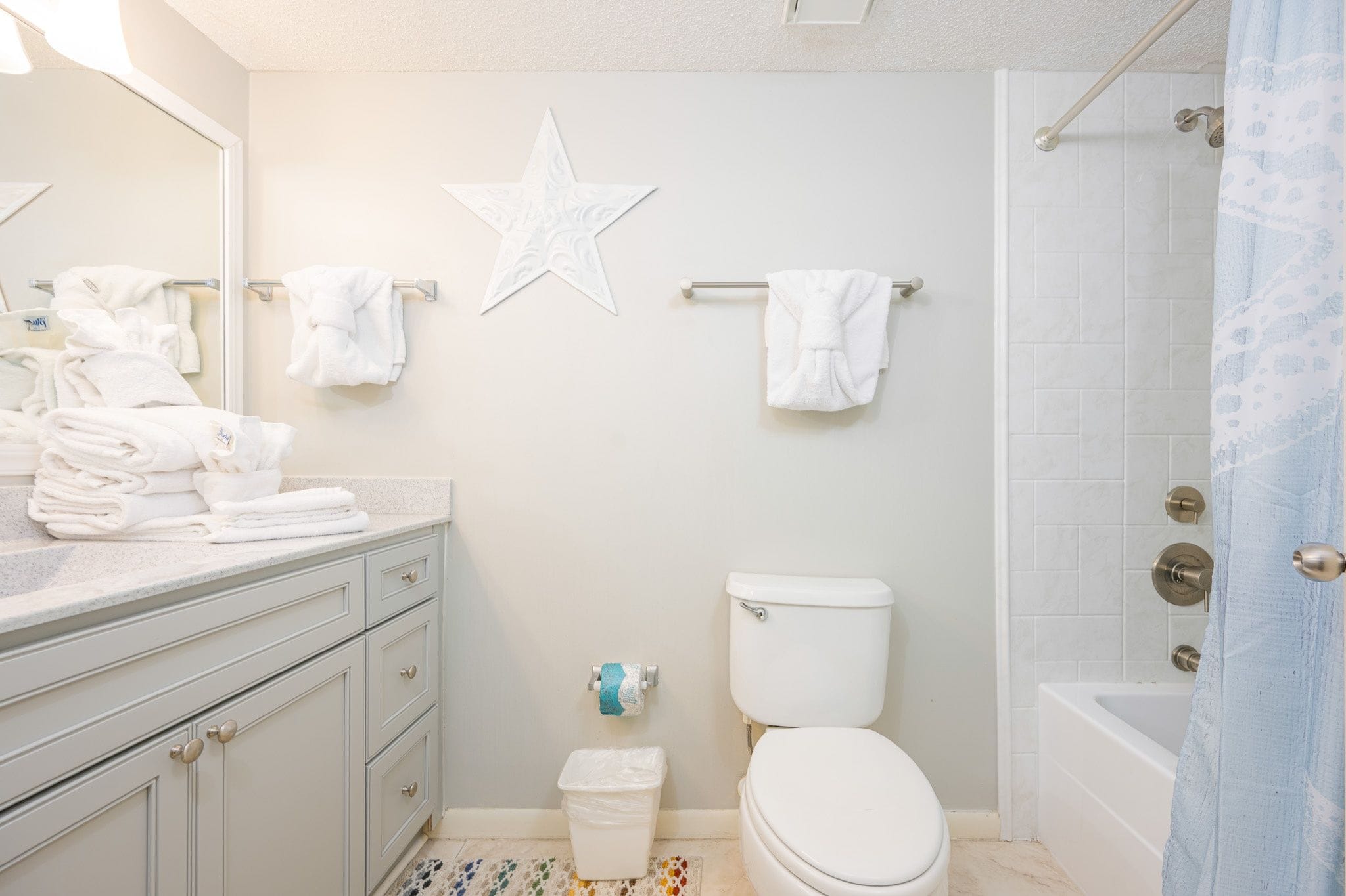 A bathroom with a toilet, sink, and shower.