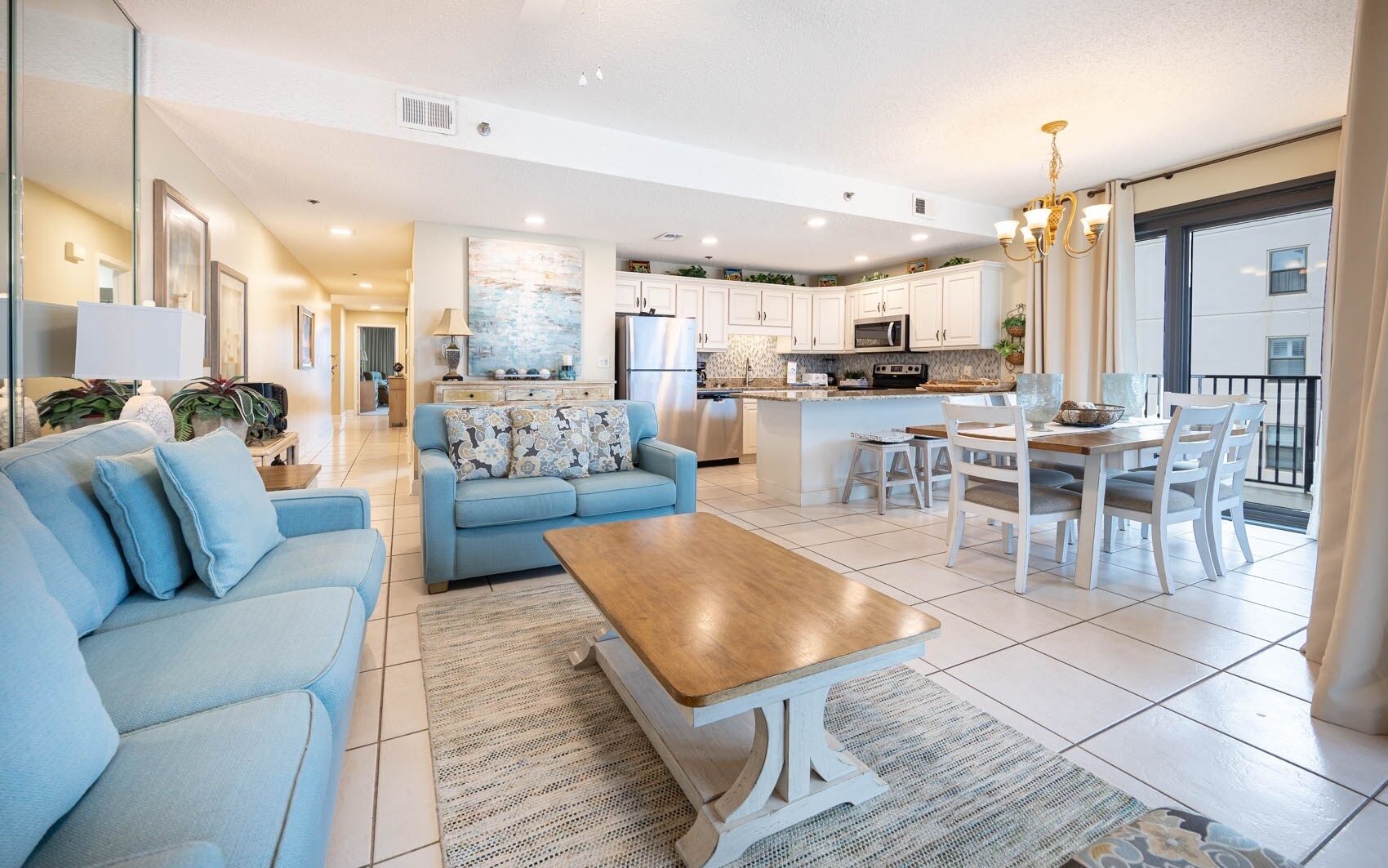 A modern living room with a sofa, coffee table, and dining area.