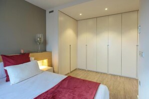 A bedroom with a bed, a bedside table with a glass, and a wardrobe. - Luxury house Alt Empordà - Serena Stays (Vilabertran)