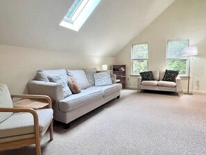 A spacious loft with a high ceiling, a large window, and a built-in bookshelf. - Comfy 4BR Home on the Quietside [KelleyTown House] (Tremont)