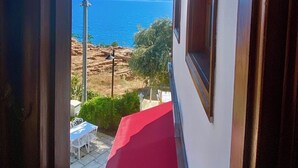 A view through a doorway to a balcony overlooking a coastal landscape with mountains in the distance. - Ulivo Hotel (Antalya)