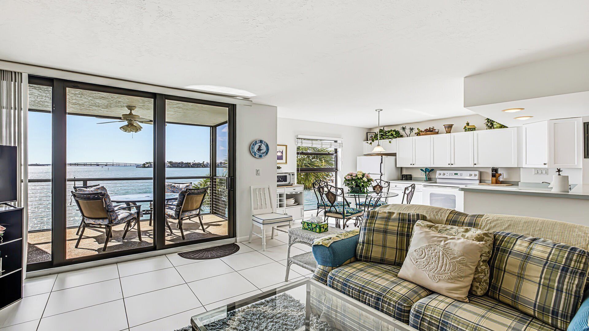 A modern living space with a balcony, a dining area, and a kitchen.