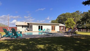 A house with a swimming pool, outdoor seating, and a fenced yard. - South Alabama Country Home With A Swimming Pool (Fairhope)