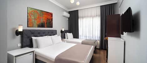 Classic Triple Room, City View | In-room safe, desk, laptop workspace, iron/ironing board