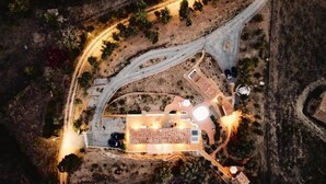 An aerial view of a property with a central building, multiple parking areas, and surrounding landscaping. - Exclusive Villa Serra de Baixo - Porto Covo (Setúbal)