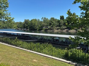 A riverside view with a covered seating area and a grassy foreground. - Quiet 2bd room condo with beautiful scenery in the heart of Branson (Branson)