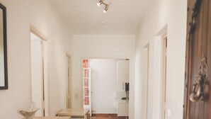 A hallway with a tiled floor, a wooden door, and a white cabinet. - Antheor Fairy Sea View 2 rooms in Villa (Saint-Raphaël)