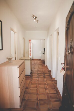 A hallway with a tiled floor, a wooden door, and a white cabinet. - Antheor Fairy Sea View 2 rooms in Villa (Saint-Raphaël)