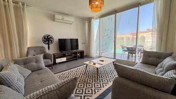 Chalet, 3 Bedrooms, Lagoon View | Living area | Flat-screen TV
