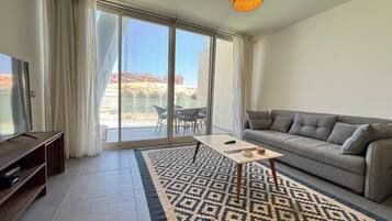 Chalet, 3 Bedrooms, Lagoon View | Living area | Flat-screen TV