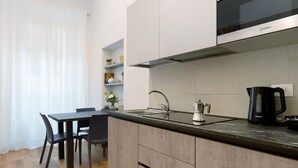 A modern kitchen with a built-in microwave, a coffee maker, and a sink. - 'Ser Lapo - Dimora Ser Lapo' with Wi-Fi and Air Conditioning (Prato)