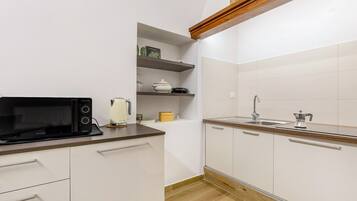 Fridge, microwave, stovetop, coffee/tea maker