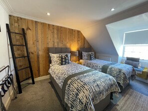 A bedroom with two beds, a wooden wall, a ladder, and a window. - 62 North, Prime, Central, Stylish,  St Andrews 4 Bed 3 bathroom Townhouse (St Andrews)