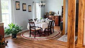 A dining area with a wooden dining table, chairs, and a chandelier. - Amazing 3-bedroom home in charming O'Brien Florida (O'Brien)