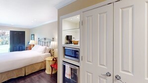A hotel room with a bed, a desk, a chair, a lamp, a television, a microwave, and a wardrobe. - Napa Silverado condo with private patio, hot tub & pool access (Napa)