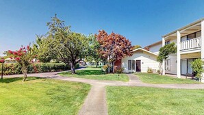 A residential area with a paved pathway, houses, and trees. - Napa Silverado condo with private patio, hot tub & pool access (Napa)