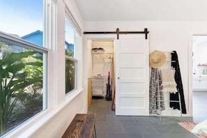A room with a large window, a sliding door, and a bench. - Bodega Bay 2BR bay-view bungalow with private sauna — dogs welcome (Bodega Bay)