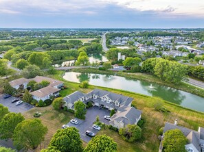 A residential area with houses, a lake, and a bridge. - 4BR Serene Waterfront Retreat, Lewes · 3 King Beds, Linens Included, Elevator (Lewes)