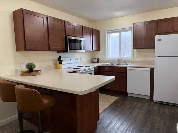 Fridge, stovetop, dishwasher, coffee/tea maker