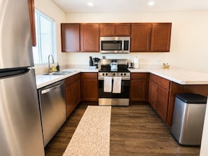 Fridge, stovetop, dishwasher, coffee/tea maker