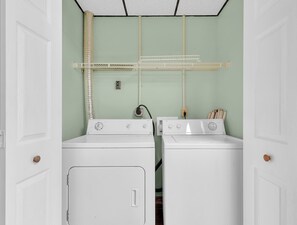 A laundry room with two white washing machines, a drying rack, and a vent. - A Family Affair #712 (Gatlinburg)